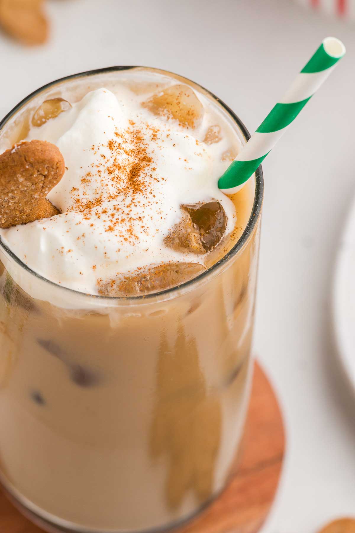 Gingerbread Iced Latte with a green and white striped straw