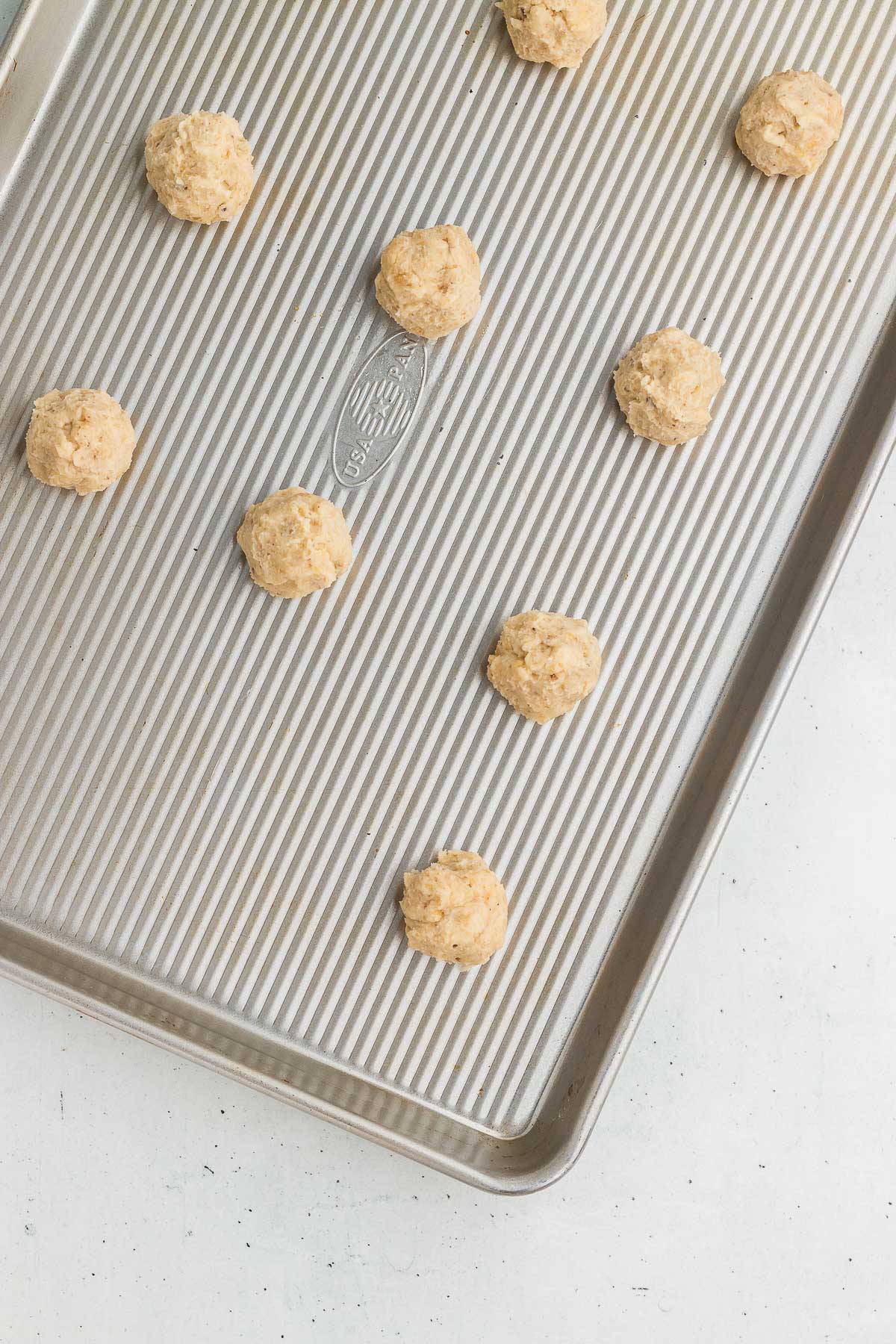 Cookie sheet with dough balls for Wooden plate full of Hidden Kiss Cookies