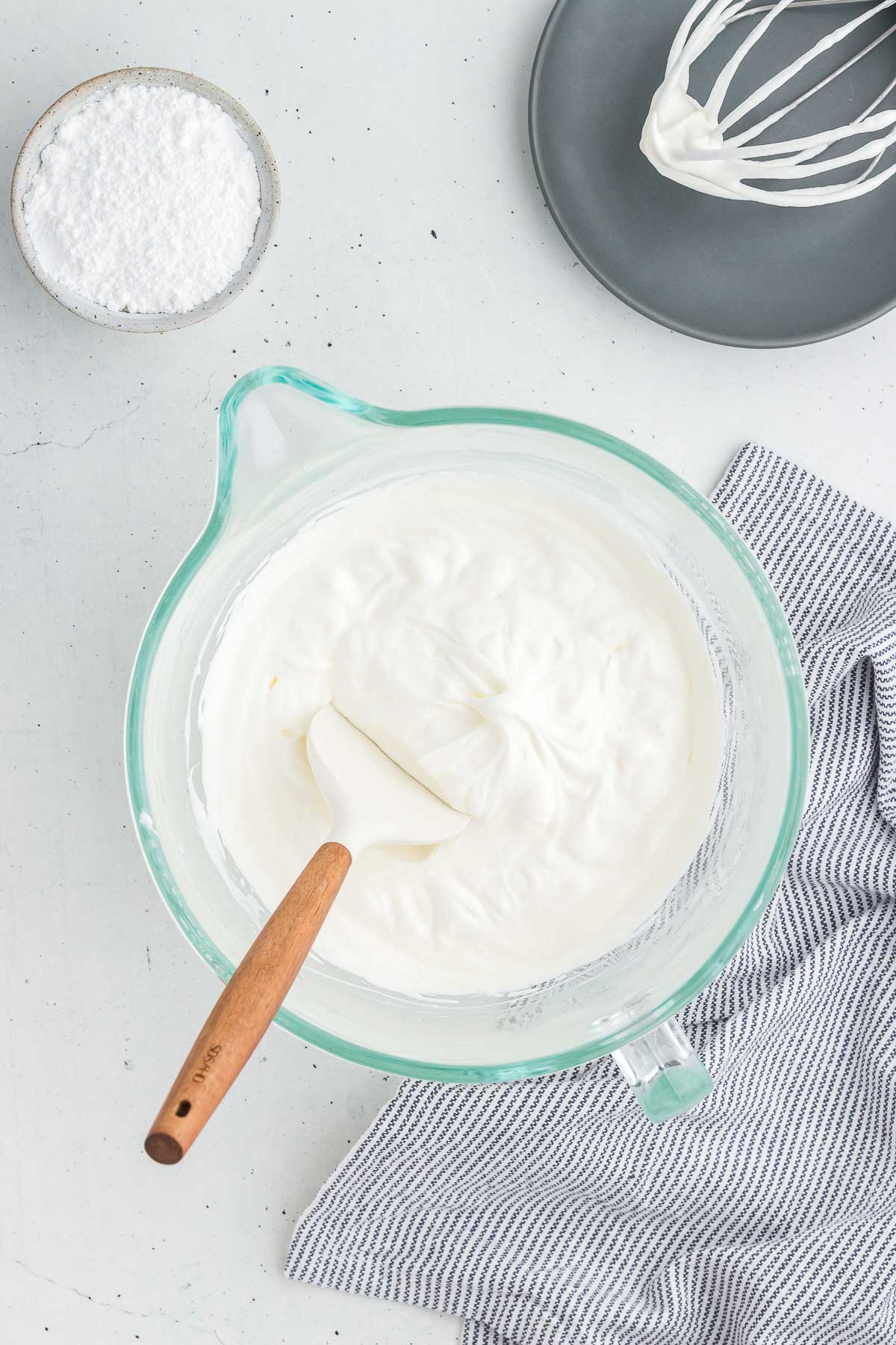 A spatula in a bowl of whipped cream