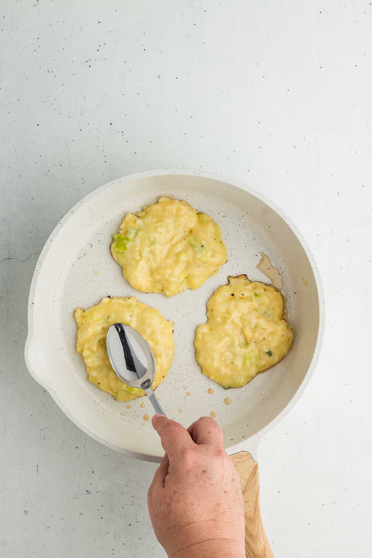 colcannon patties in a frying pan cooking