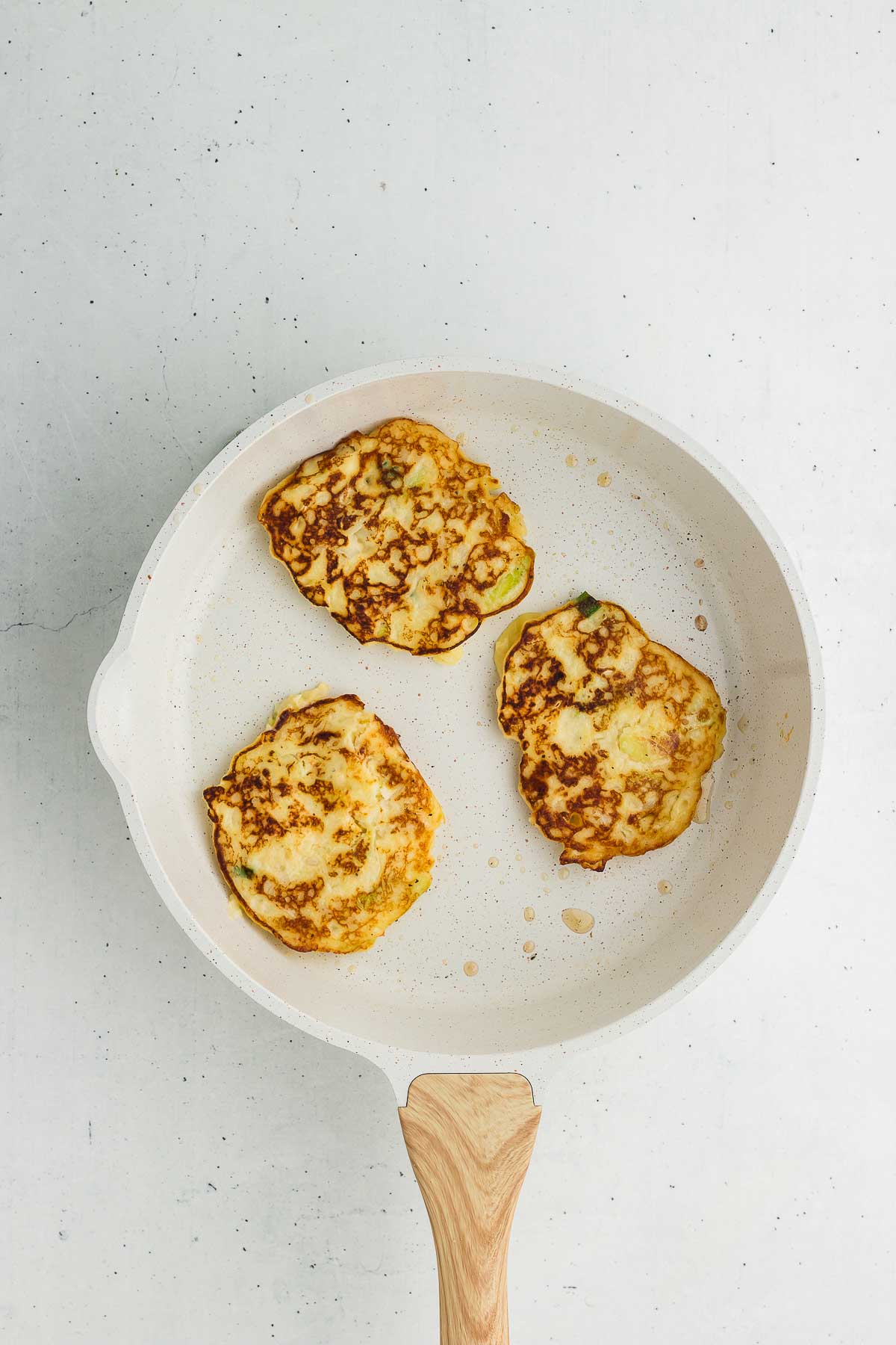 browned colcannon cakes in a frying pan