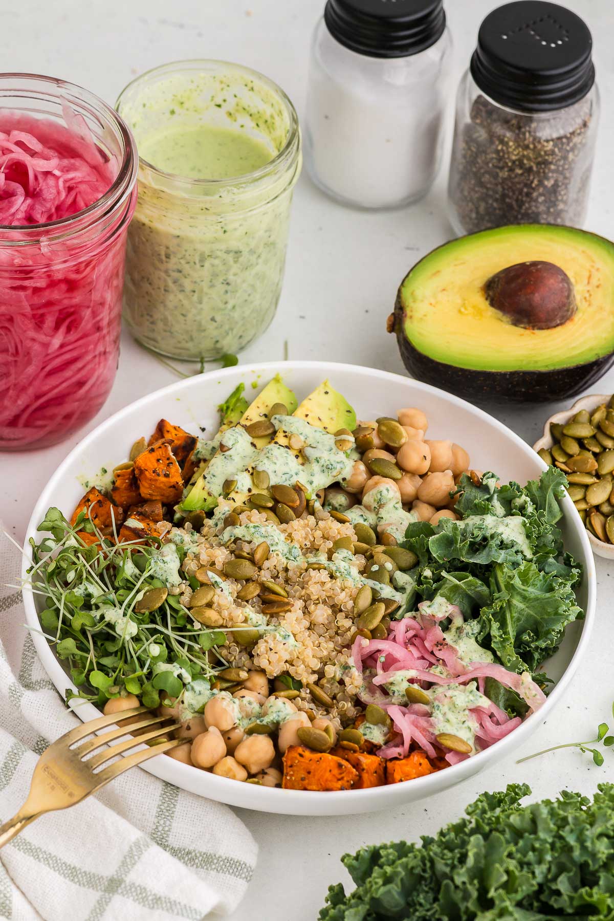 Grain bowl in a white bowl with windowpane linen in the background