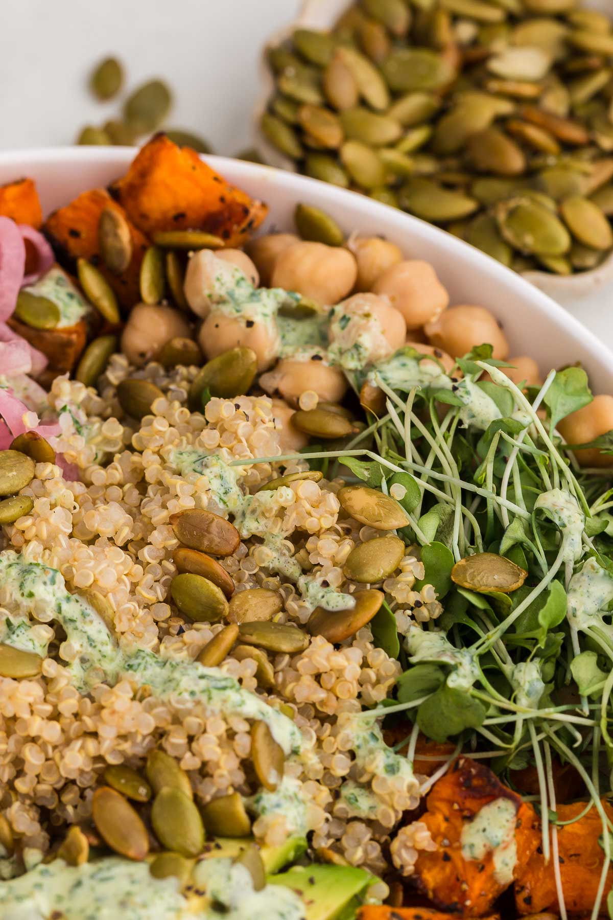 Grain bowl in a white bowl with micro greens