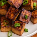 close-up of baked tofu with scallions