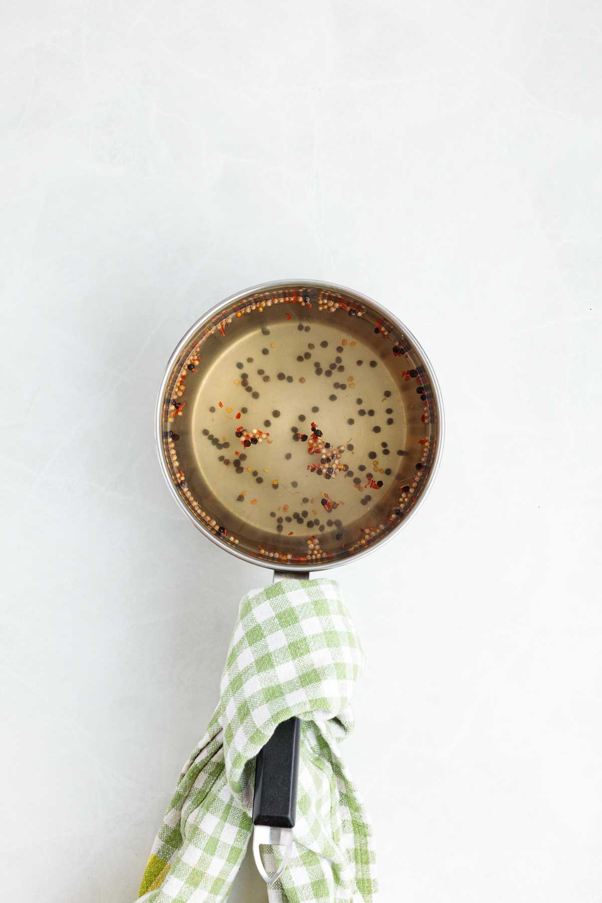 a saucepan of brine for quick asparagus pickles