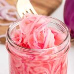 quick-pickled red onions with a silver fork