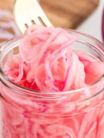 quick-pickled red onions with a silver fork
