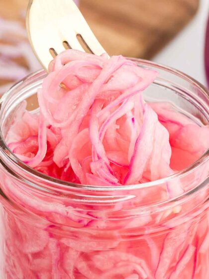 quick-pickled red onions with a silver fork