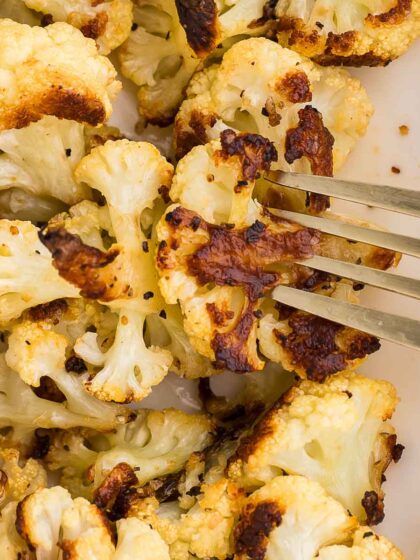 A fork pierces a piece of Roasted Cauliflower