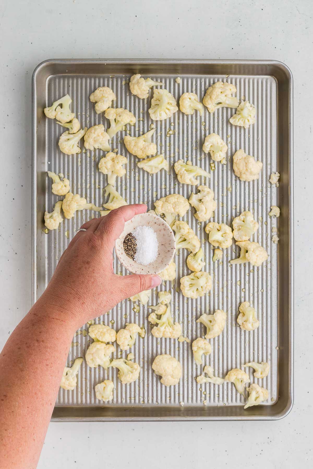 Adding seasonings to Roasted Cauliflower