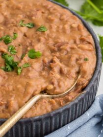 A spoon scoops out a serving of Homemade Refried Beans