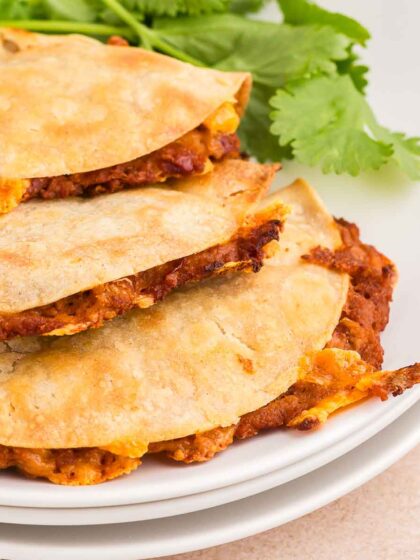crispy refried bean tacos on a white plate