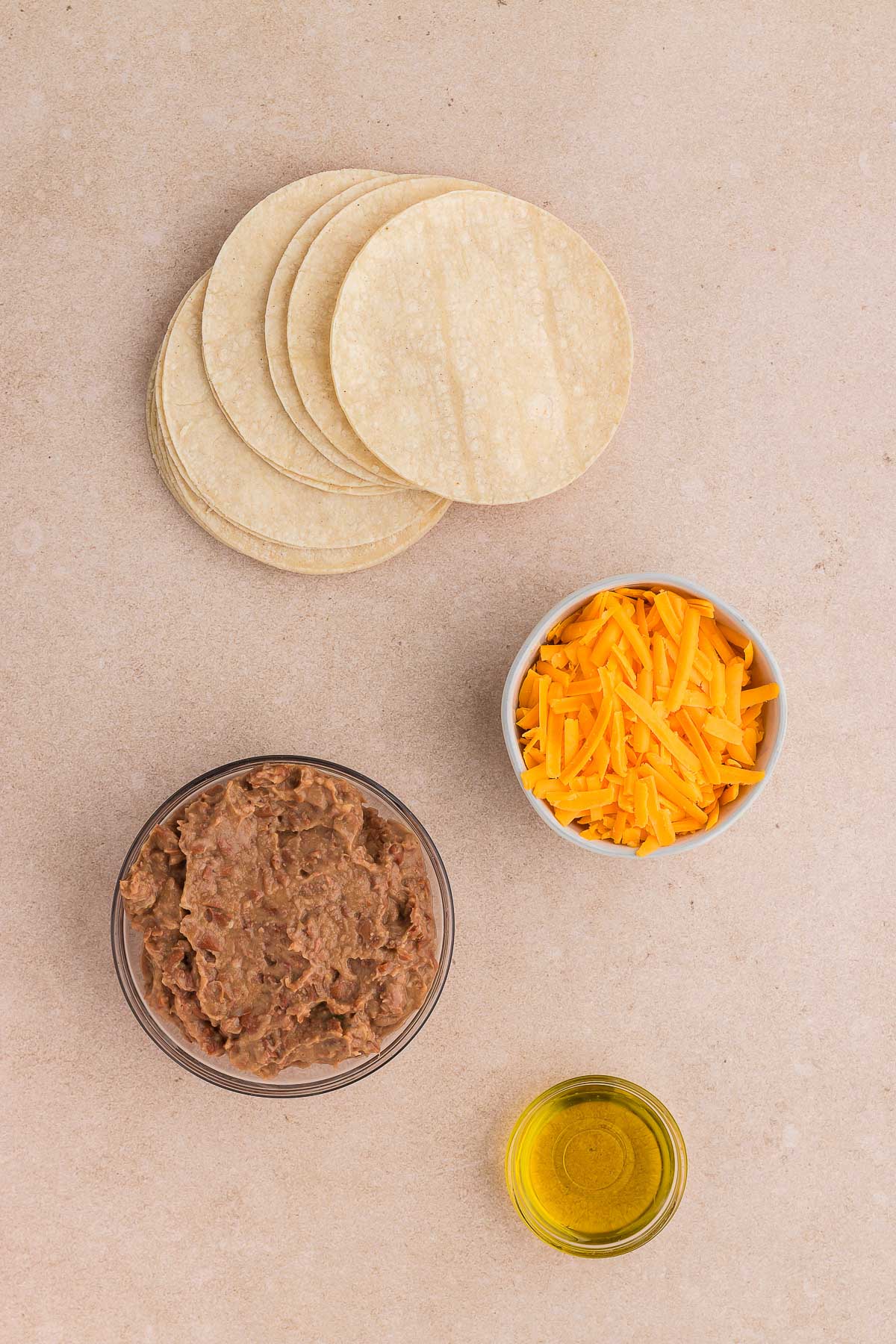 Ingredients for crispy refried bean & cheese burritos