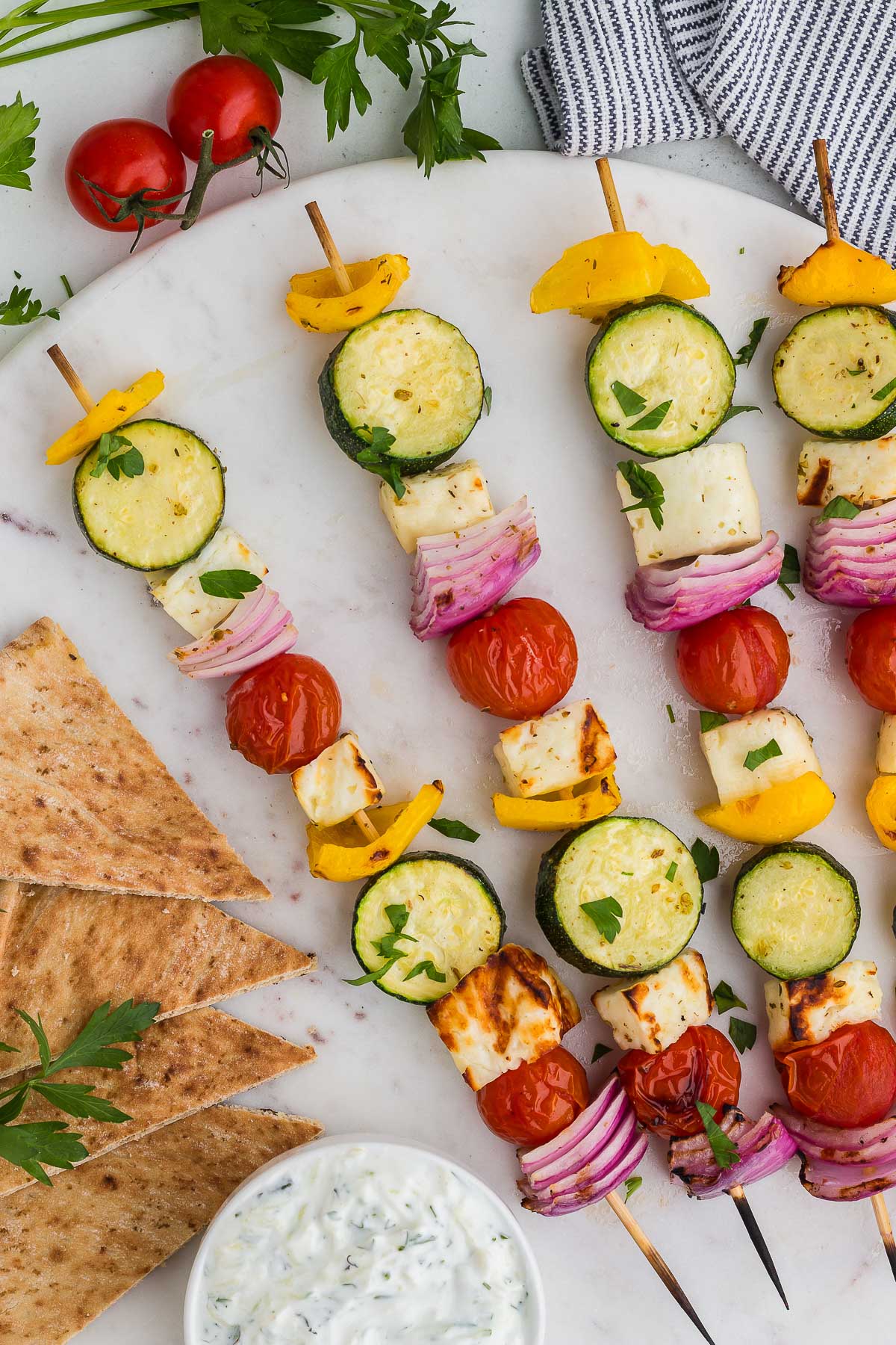 Grilled halloumi and vegetable skewers with pita and tzatziki