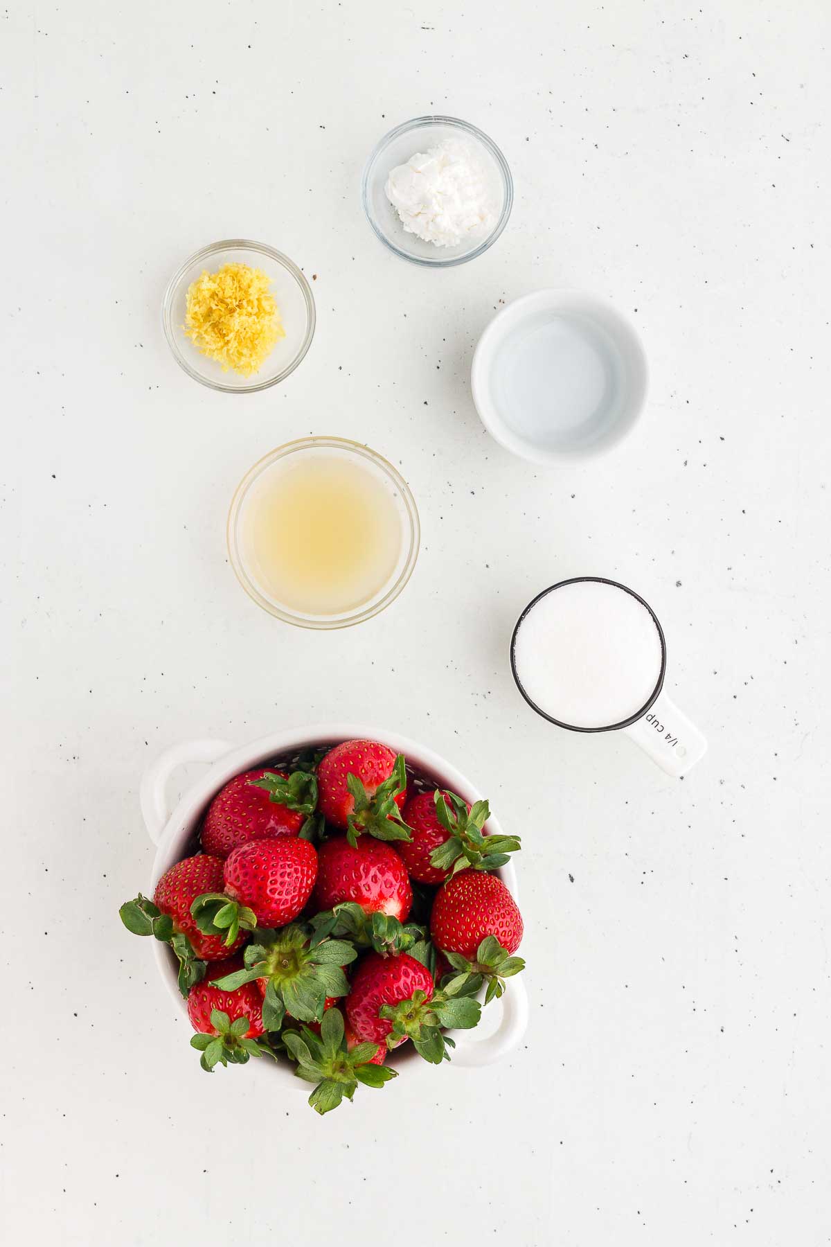 Ingredients for fresh strawberry sauce include fresh strawberries, cornstarch, water, lemon juice, lemon zest, and sugar.