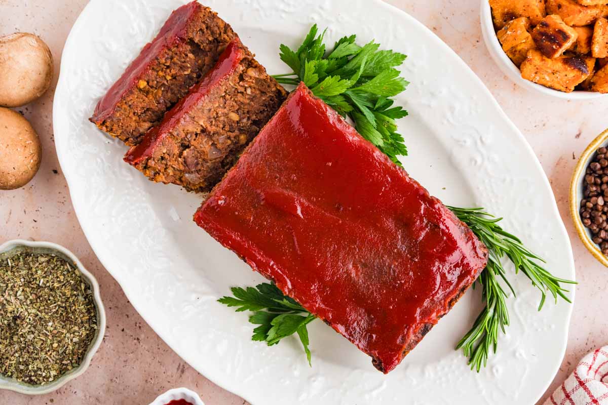 Vegetarian Meatloaf on a white platter with garnishes