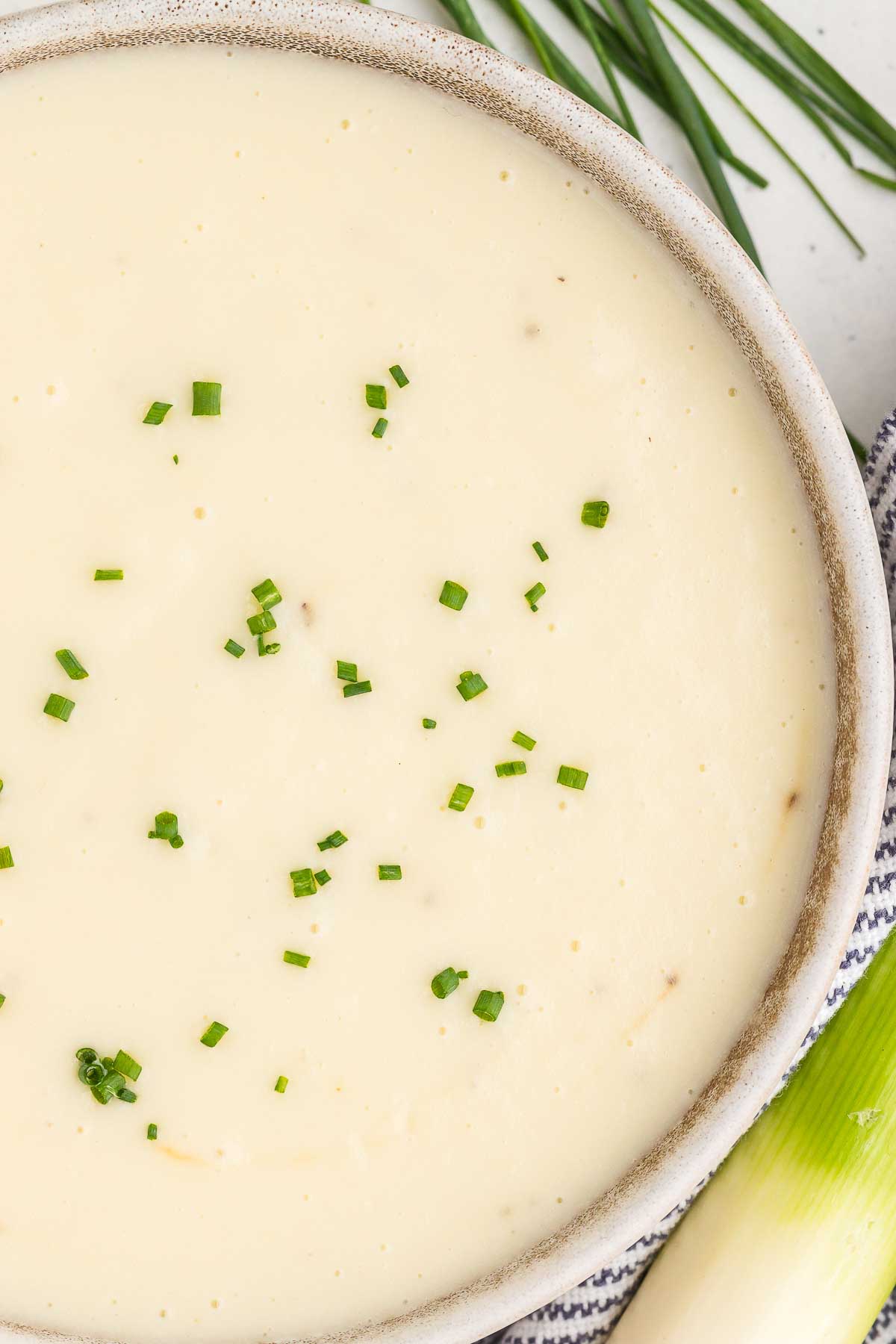 close-up view of potato leek soup in a rustic bowl