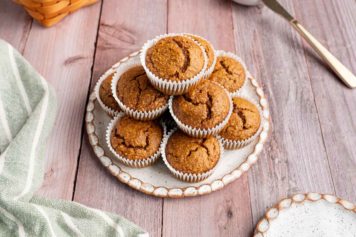Blender Pumpkin Muffins on a plate with a distressed wood background