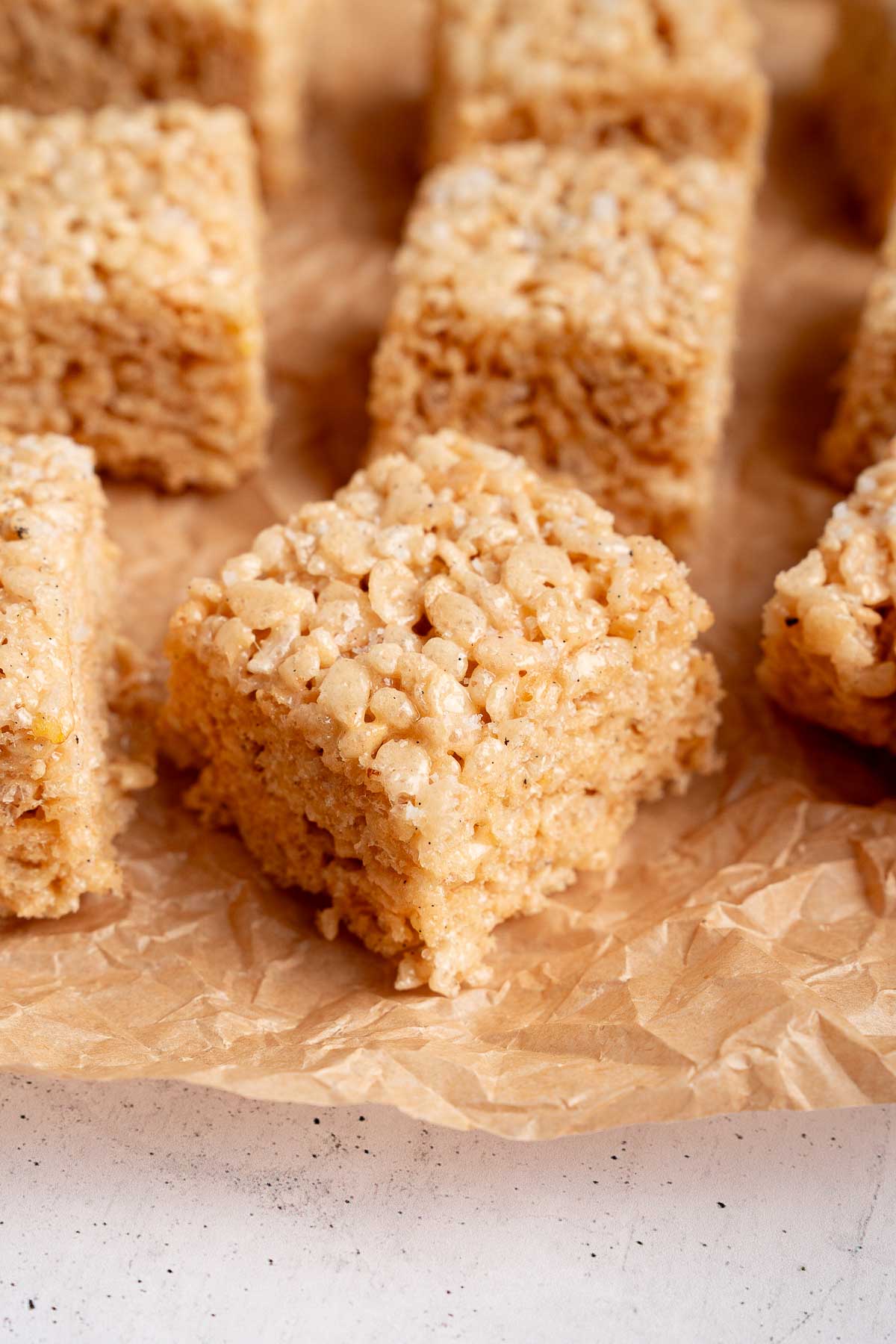 Rice Krispie Treats with brown butter and vanilla on parchment paper