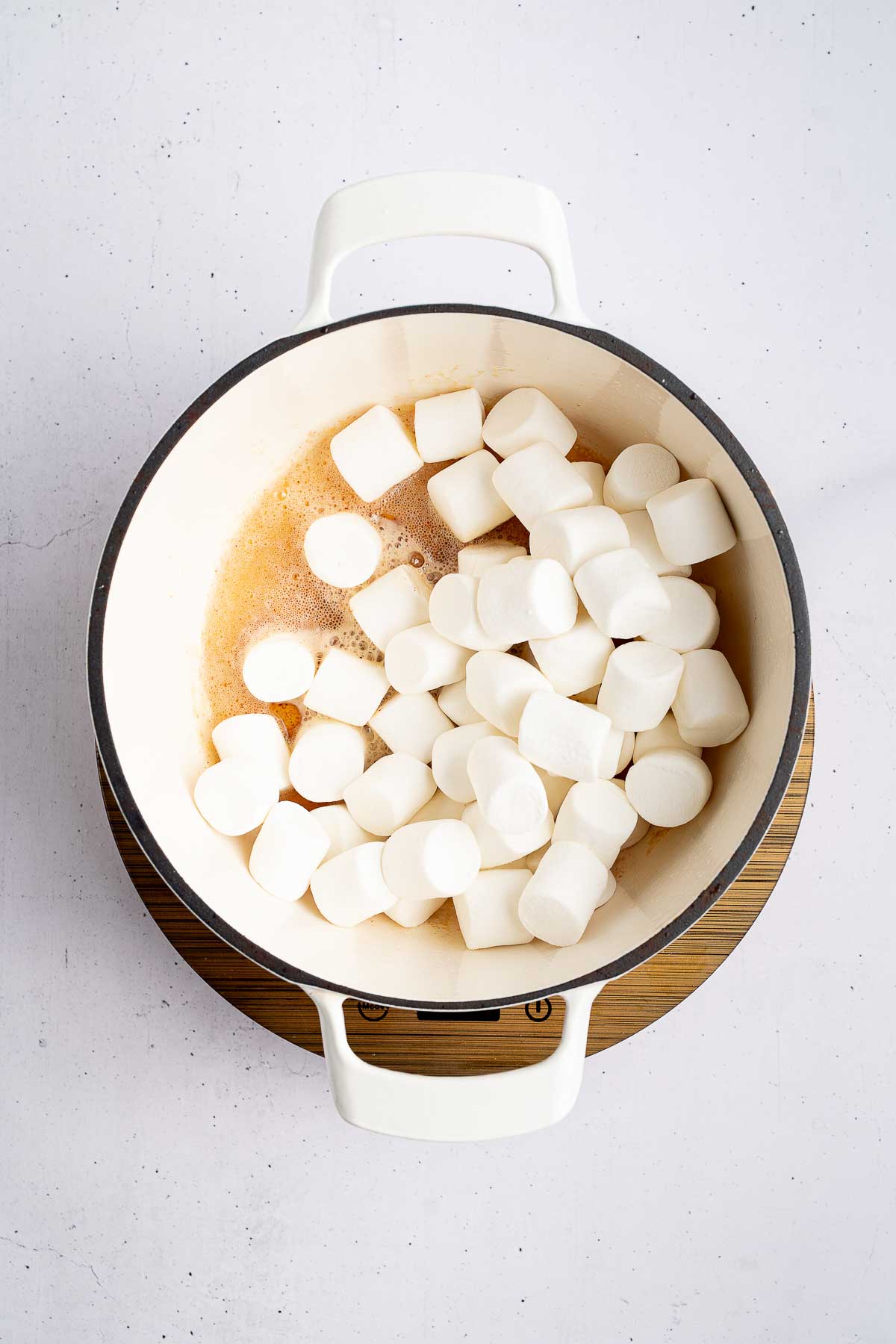 Adding marshmallows for Brown Butter Rice Vanilla Krispie Treats