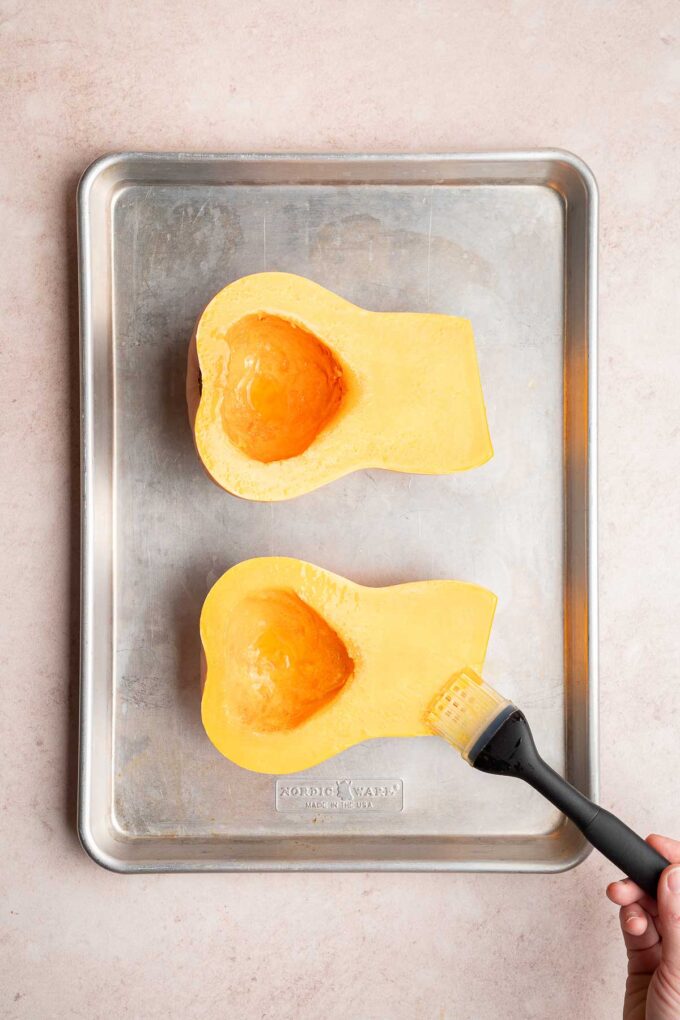 brushing butternut squash halves with olive oil
