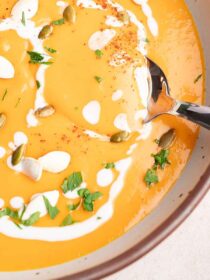 top view of roasted butternut squash soup with coconut milk and spoon