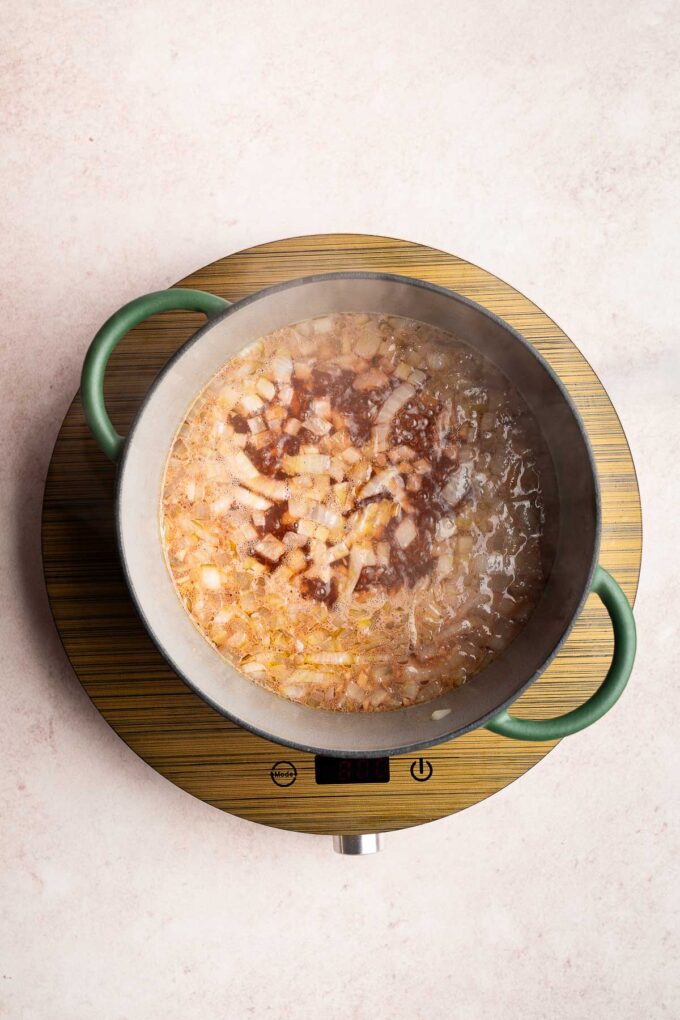 adding broth and ginger to butternut squash soup