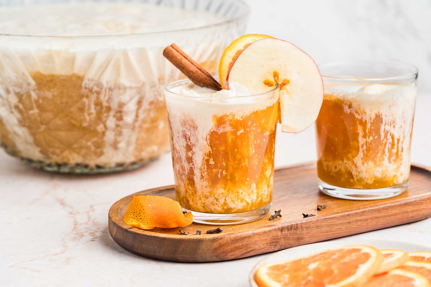 punch with apple cider and vanilla ice cream in front of a punchbowl