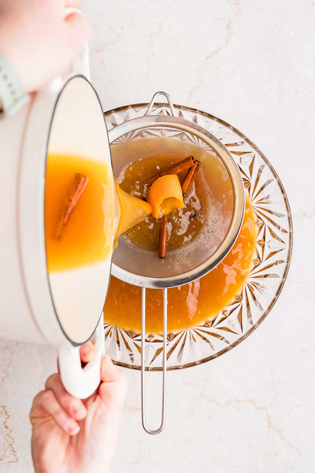 straining cider into punch bowl