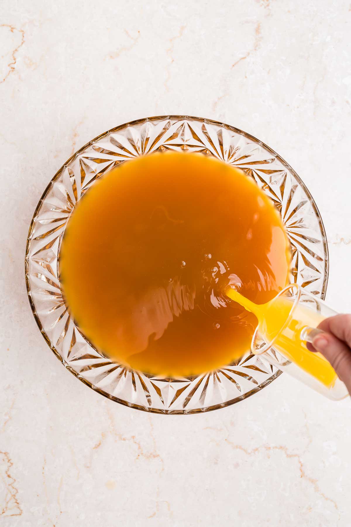 adding orange juice to punch