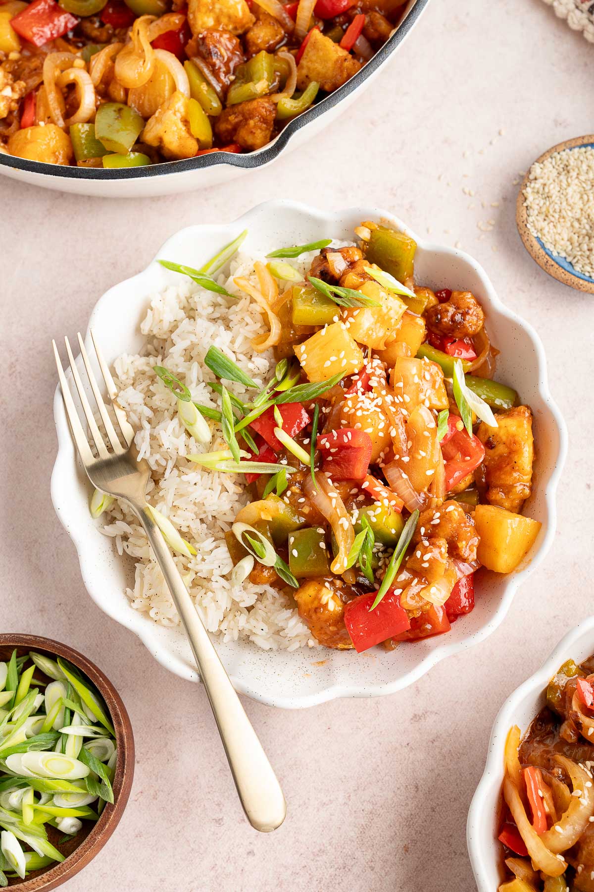 bowl of sweet and sour tofu with a fork