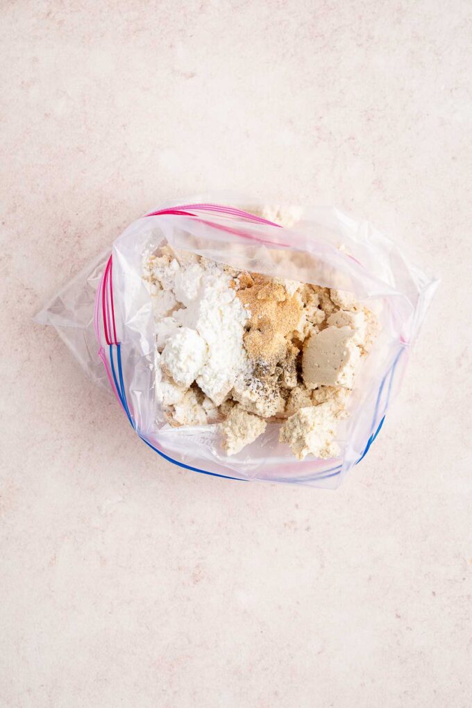 adding tofu to ziplock with cornstarch and seasonings